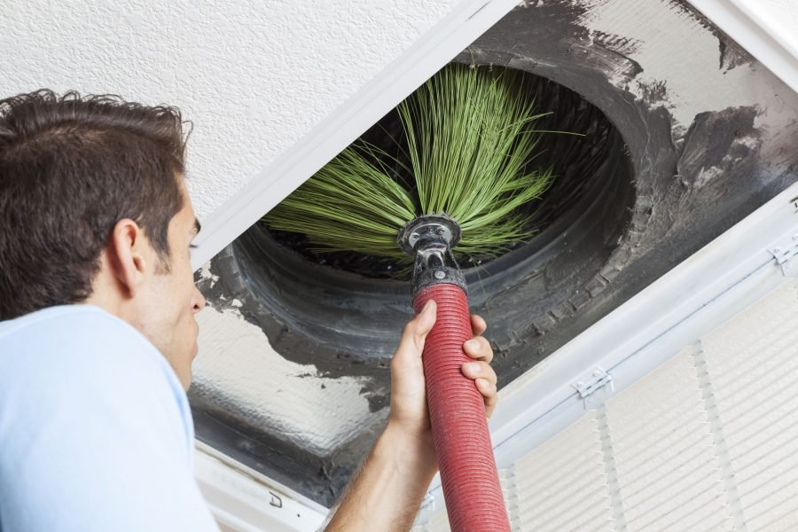 Man cleaning air ducts in home.